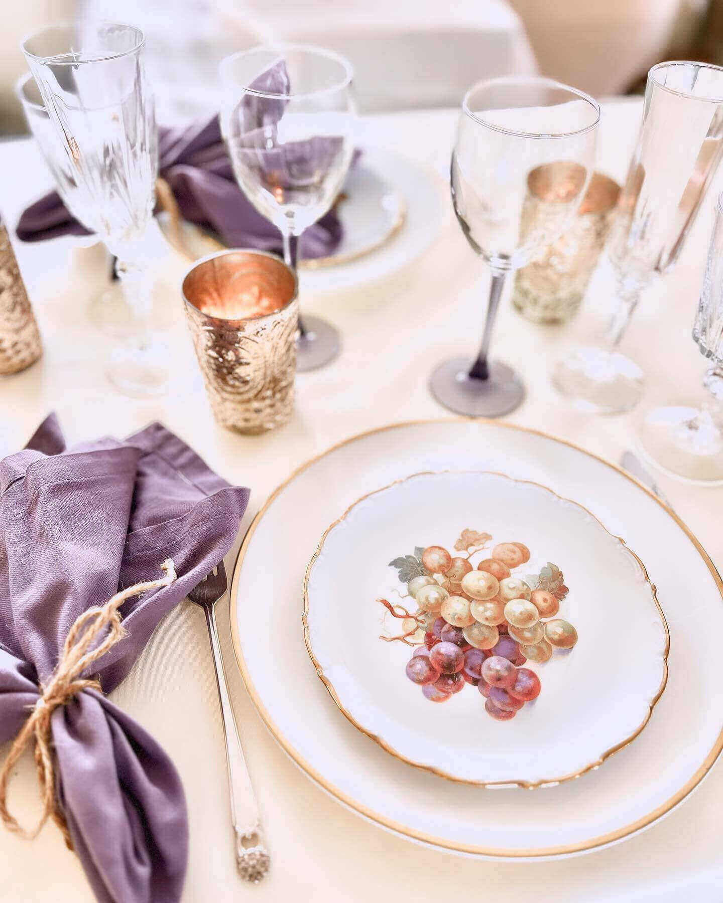 Autumn harvest plates and purple napkins, clear glassware and pewter goblets