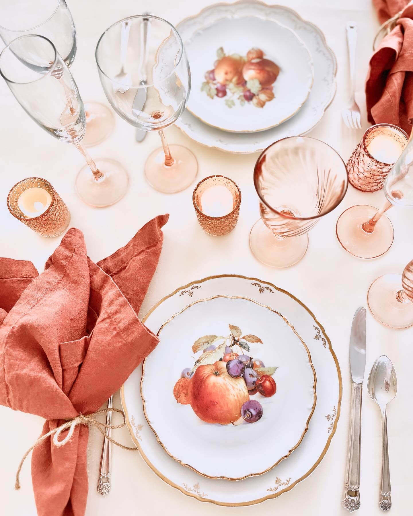 Autumn orchard plates, cinnamon colored linen napkins tied witht string, blush glassware, mercury tealight holders, silver cutlery on a white tablecloth